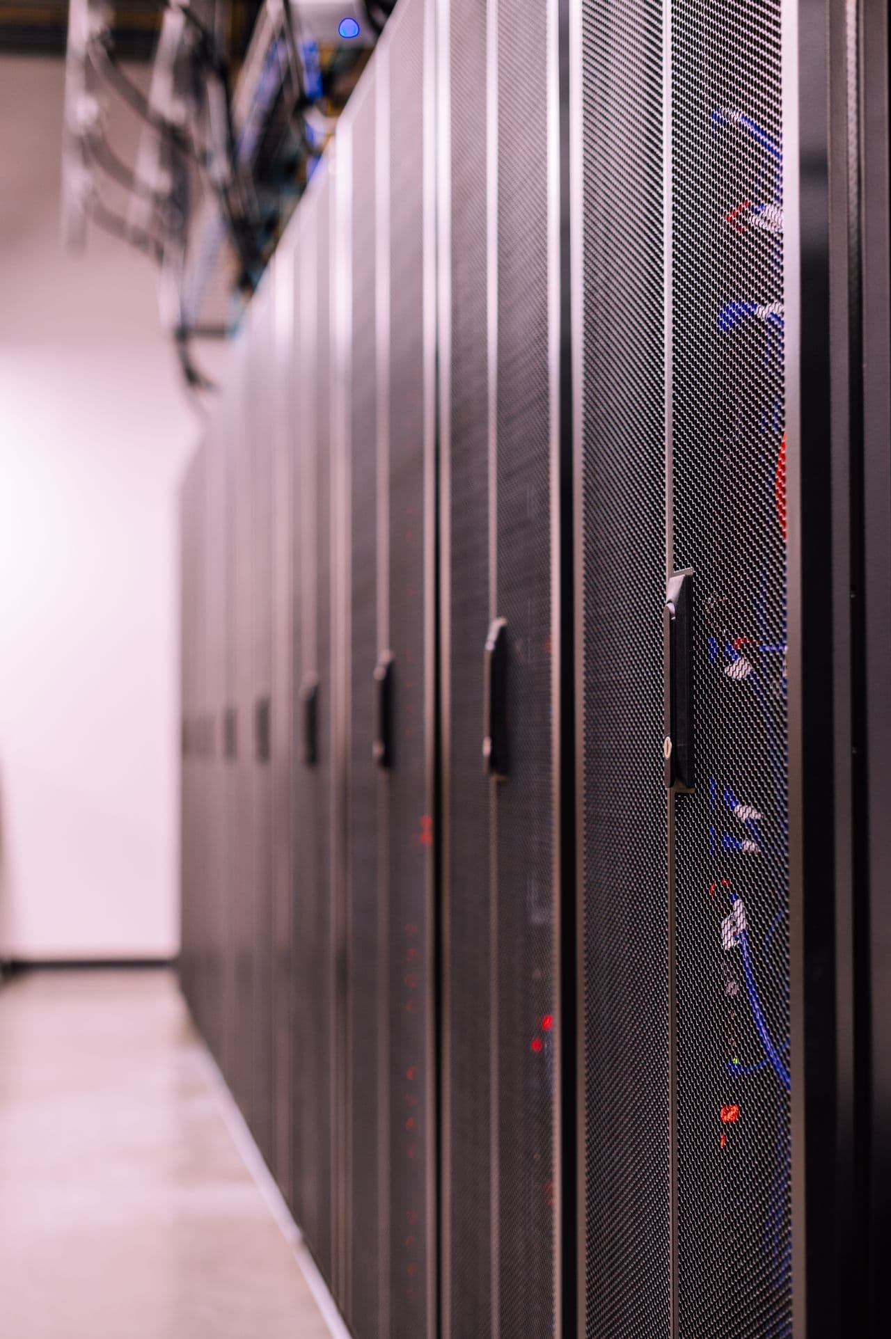 Data centre aisle lined with perforated rack doors.